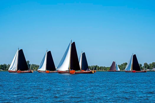 Traditional Frisian wooden sailing ships in a yearly competition in the Netherlands