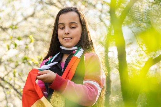 United Arab Emirates concept with happy child girl with red the United Arab Emirates flag. Learn Arabic language.