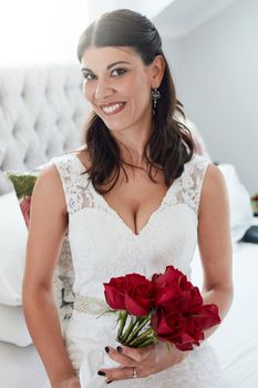 Theres nothing more romantic than red roses. an attractive young bride on her wedding day