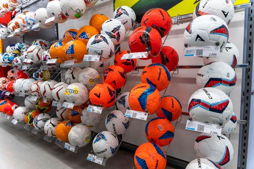 SAINT PETERSBURG, RUSSIA - AUGUST 14, 2022: new volleyballs on the shelf of a sporting goods store. colorful sports equipment in the sports store
