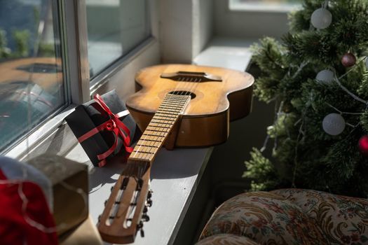 Flat lay composition with guitar and Santa hat, space for text. Christmas music.