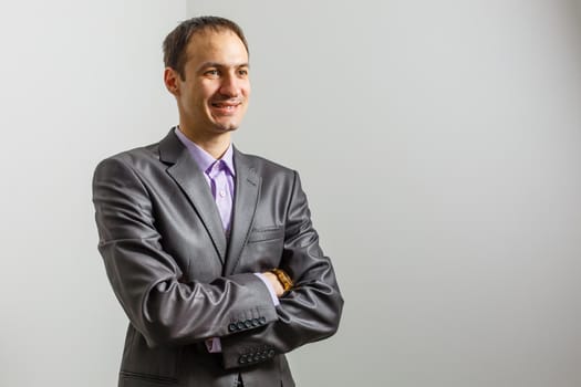 Cool businessman standing on grey background