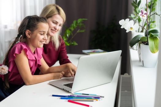 Cute little girl with therapist. Young woman teacher and child on private lesson