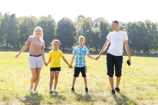 happy family playing in the green field.