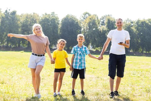 Happy family enjoying life together at meadow outdoor