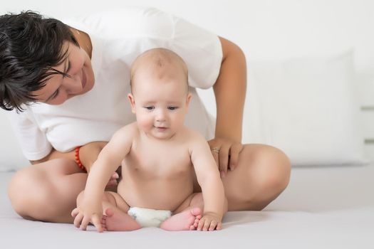 Portrait of a mother with her 6 months old baby, top view point.