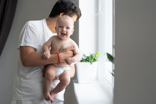 Portrait of a mother with her 6 months old baby, top view point.