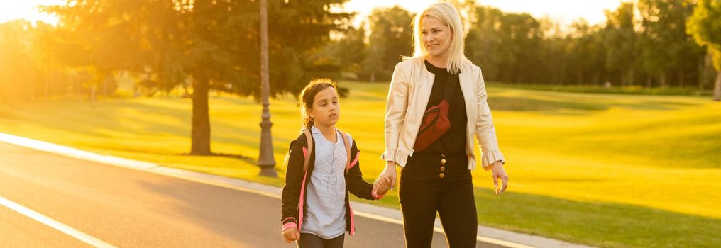 Mother taking daughter to school.