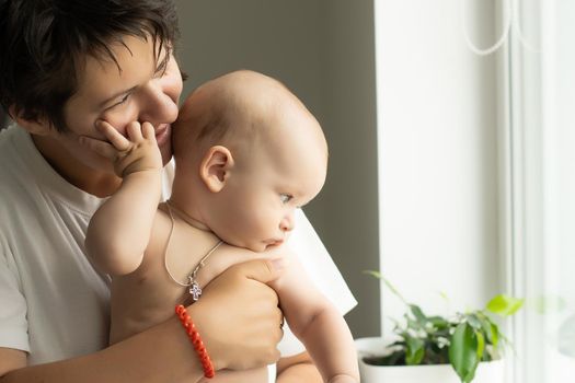 picture of happy mother with baby in hands.