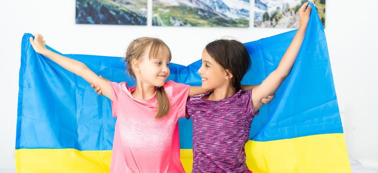 children carry fluttering flag of Ukraine. Ukraines Independence Day. Flag Day. Constitution day. Girls with flag of Ukraine