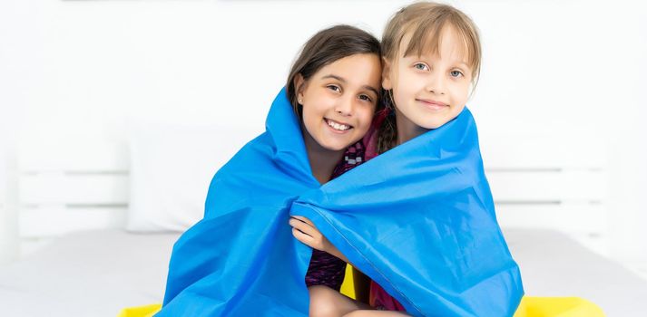 children carry fluttering flag of Ukraine. Ukraine's Independence Day. Flag Day. Constitution day. Girls with flag of Ukraine