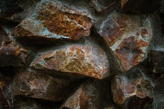Close-up view of rough stone wall textured background