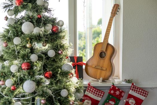 Flat lay composition with guitar and Santa hat, space for text. Christmas music.