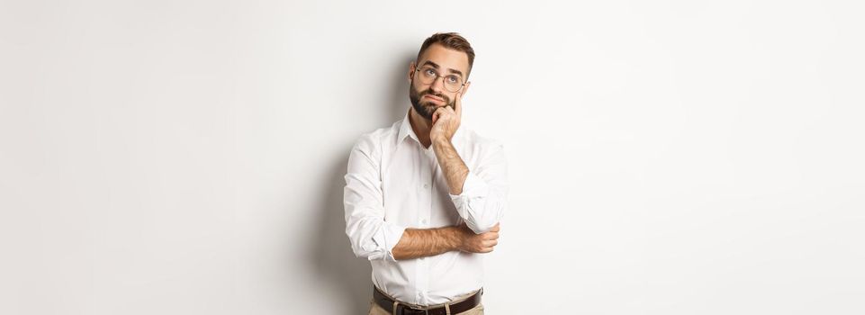 Troubled manage looking away thoughtful, feeling tired, standing over white background. Copy space