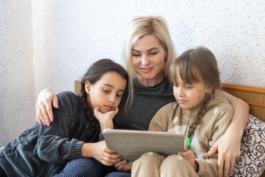 Mother with two children using Tablet PC.