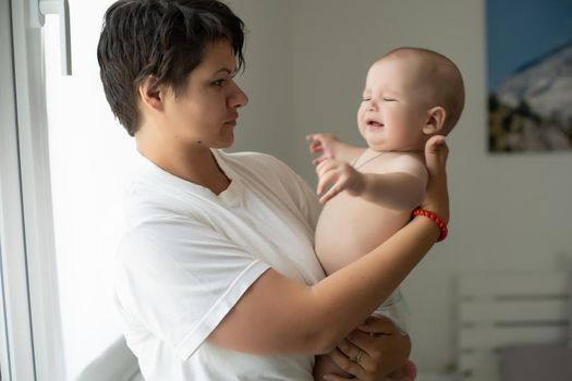 Portrait of a mother with her 6 months old baby, top view point.