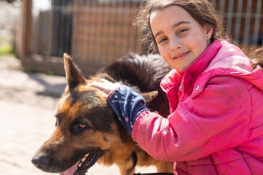 Little latin girl with her big dog in the countryside.