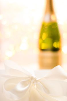 Romantic celebration, lifestyle and luxury present concept - The bottle of champagne and holiday gift box