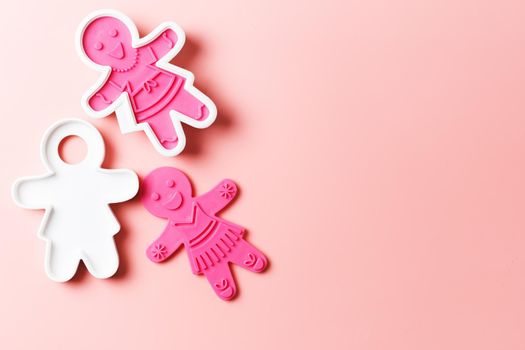Preparing for Christmas. Pink cookie cutters isolated on a pink background. copy space