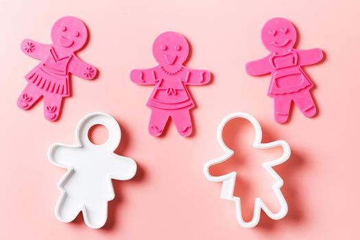 Preparing for Christmas. Pink cookie cutters isolated on a pink background. copy space