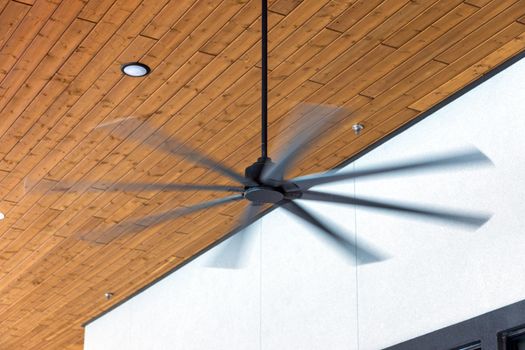 HVLS ceiling fan big fans for hot air cooling. Large ceiling fans for open air building with brown ceiling and white wall on background