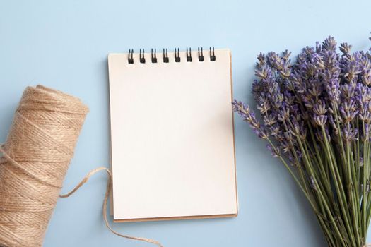 Blank sheet of flat lay notebook with lavender, twine. Write your message. High quality photo
