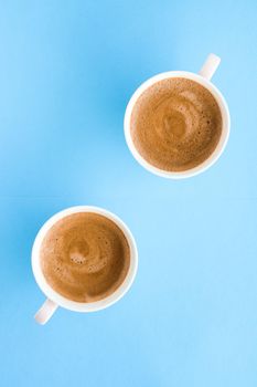 Breakfast, drinks and modern lifestyle concept - Hot aromatic coffee on blue background, flatlay