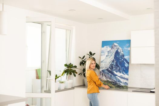 Woman hanging a photo canvas on a wall