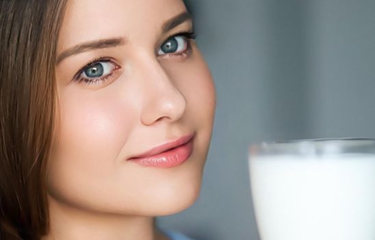 Diet and wellness, young woman with glass of milk or protein shake cocktail, portrait