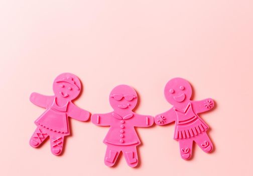 Preparing for Christmas. Pink cookie cutters isolated on a pink background. copy space