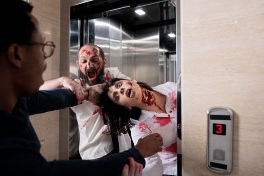 Cruel scary zombies chasing afraid man, leaving elevator to eat brain and attack office. Scared frightened person running from terrifying evil monsters with wounds, walking dead hunting.