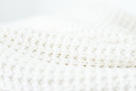 Knitwear, fabric textures and handmade items concept - Warm knitted clothes, soft and white