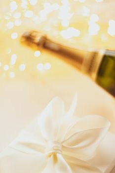 Romantic celebration, lifestyle and luxury present concept - The bottle of champagne and holiday gift box