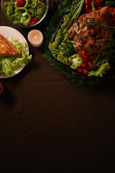 Thanksgiving dinner background with roasted turkey or chicken and all sides dishes. Thanksgiving celebration traditional dinner concept.