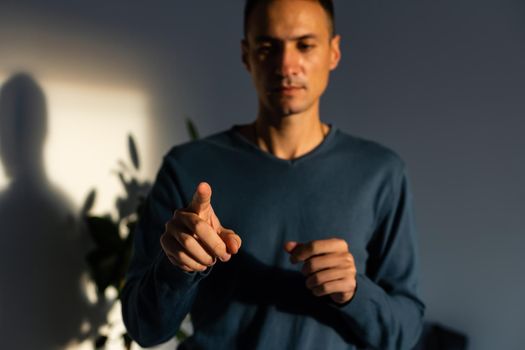 Young handsome man wearing casual t-shirt presenting with hand and pointing with finger