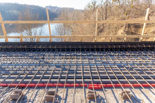 Restoration of the city bridge. New reinforcement binding have been laid, as well as cables and other communications protected by plastic casings. The plot is prepared for concreting.