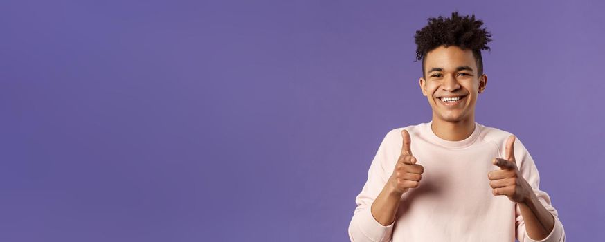 You got it. Close-up portrait of smiling cute young hispanic man saying good luck, pointing fingers at camera with pleased cute grin, encourage person apply for job, headhunter picking new candidates.