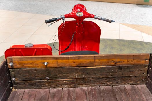 vintage old three-wheeled cargo scooter with wooden body. retro scooter for the delivery of goods and delivery to small shops and farms.