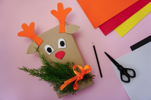 Step-by-step instructions for making packaging for a gift in the form of a deer. A gift from a cardboard package.