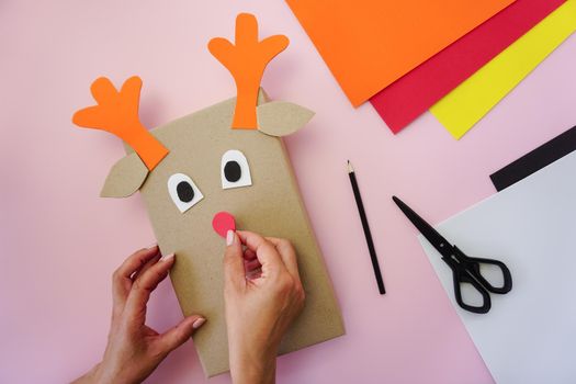 Step 4. Making a gift package in the form of a Christmas deer. High quality photo