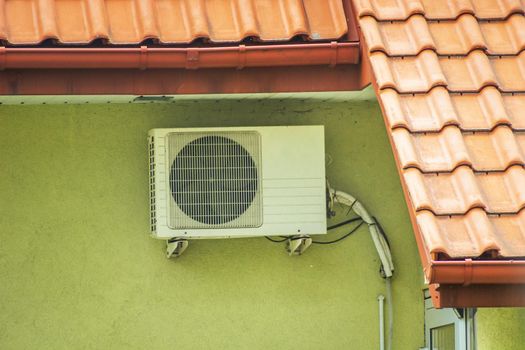 Single air conditioner hanging on the wall of the building