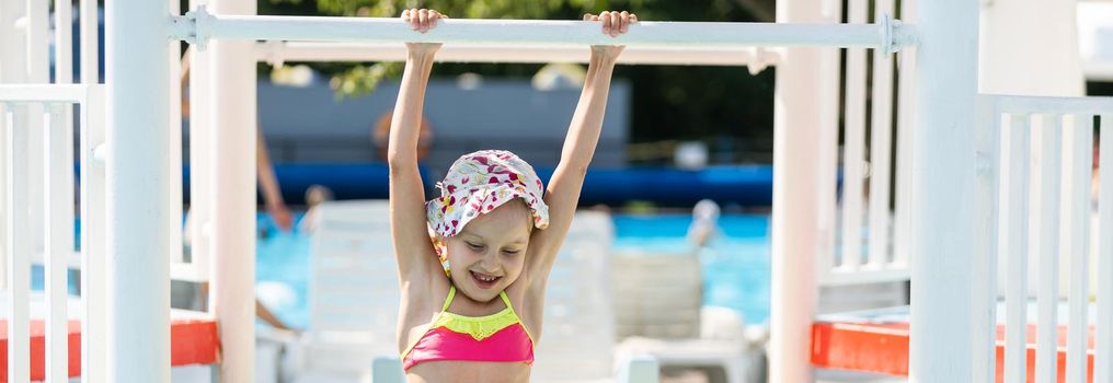 Swimming - little girl playing in blue water - space for text