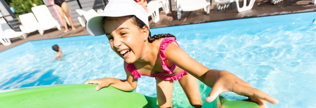 Little girl in swimming pool. Summer outdoor