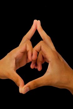 Shot of male hands doing Kalesvara mudra isolated on black background.