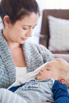He fills my heart with so much love. a mother holding her sleepy baby boy at home