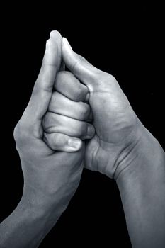 Shot of male hands doing Shankh mudra isolated on black background.