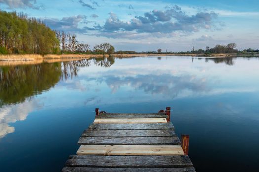 Wooden pier jutting out into the lake, spring view, eastern Poland