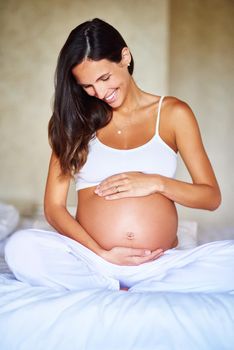 Caring for her baby bump. a pregnant woman holding her belly