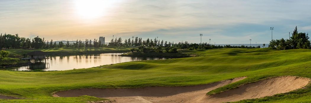 BANNER LONG FORMAT, crop it. Orange dawn sun golf pond reflection hills green fabulous background.