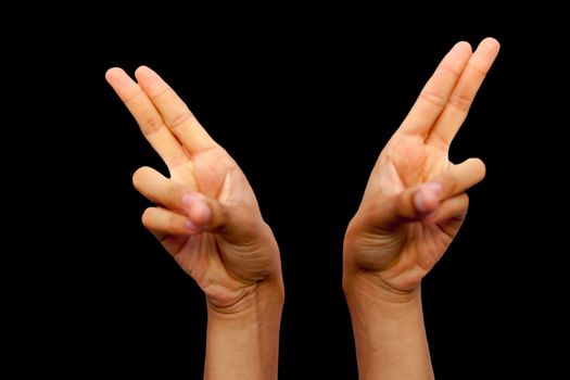 Shot of pair of hands doing Kapitthaka Mudra or Smiling Buddha Mudra isolated on black background.